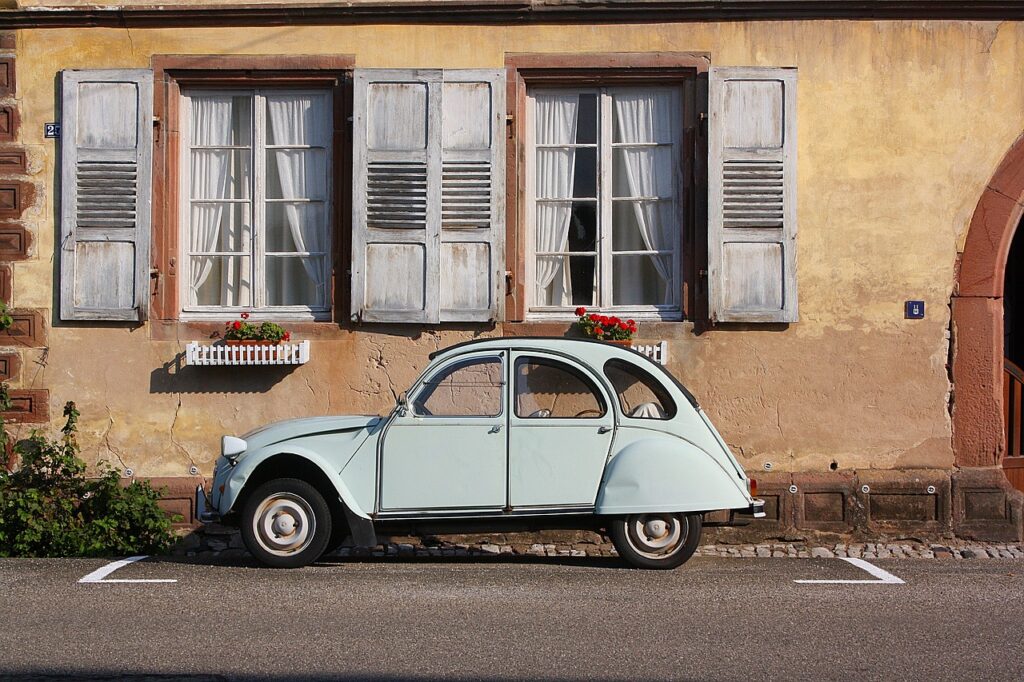 beetle car parked in front of old building | volunteering abroad