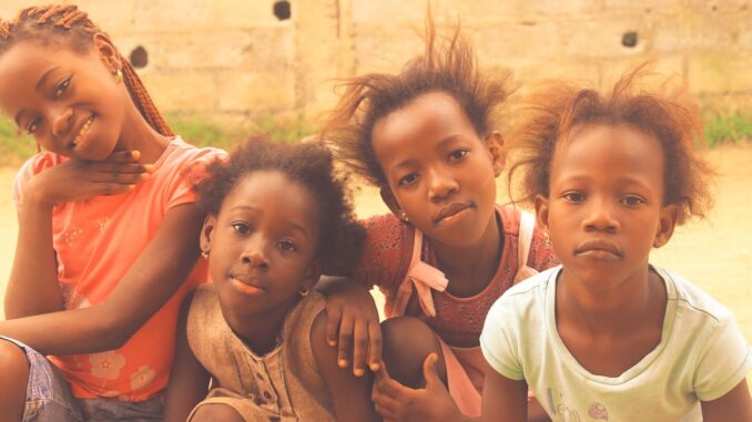 African girls looking at the camera | equality for women in Congo