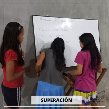 Three girls solving a math problem on a whiteboard | women empowerment