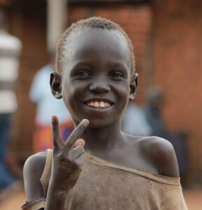 ugandan kid looking at the camera | Empowering Vulnerable Communities