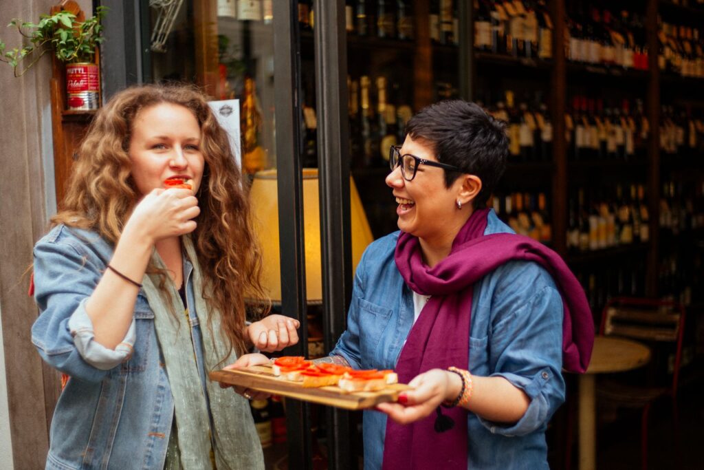 local woman showing traditional snacks to a tourist | sustainable tourism